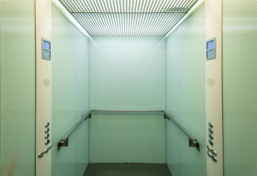 Empty elevator cabin showcasing a clean and minimalist interior with soft lighting.